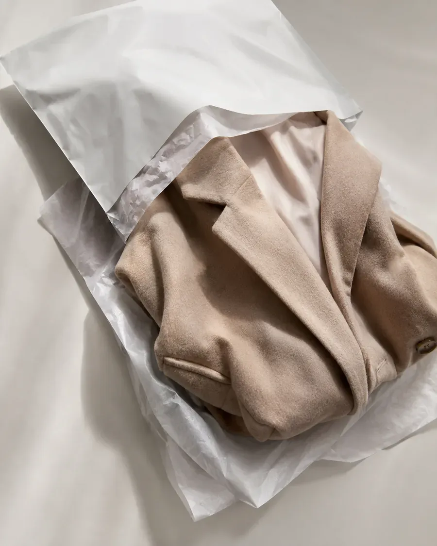 A returned coat as it arrived, creased from being repacked into its mailer.