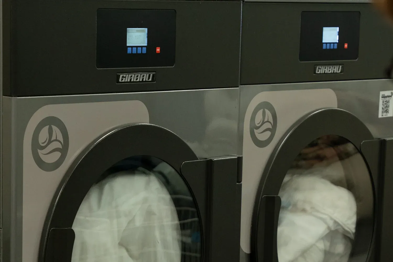 Professional wet-cleaning machines with garments inside.
